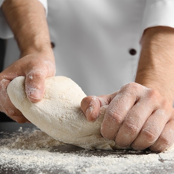 man kneading dough