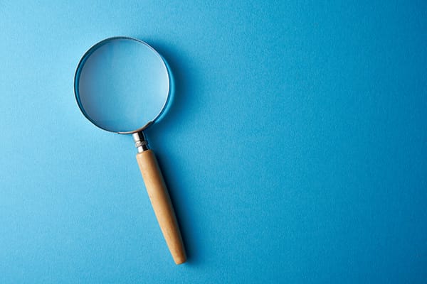 Magnifying glass on the blue background.