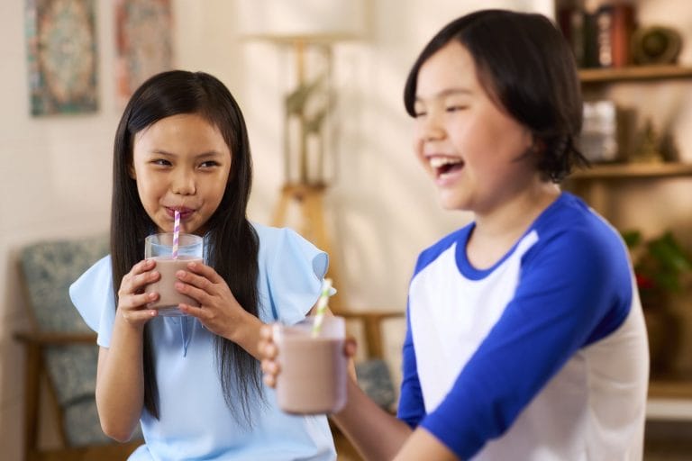Two children drinking milk