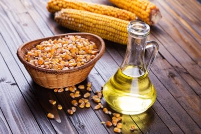 Corn,Oil,In,Bottle,On,Dark,Wooden,Background.,Selective,Focus,