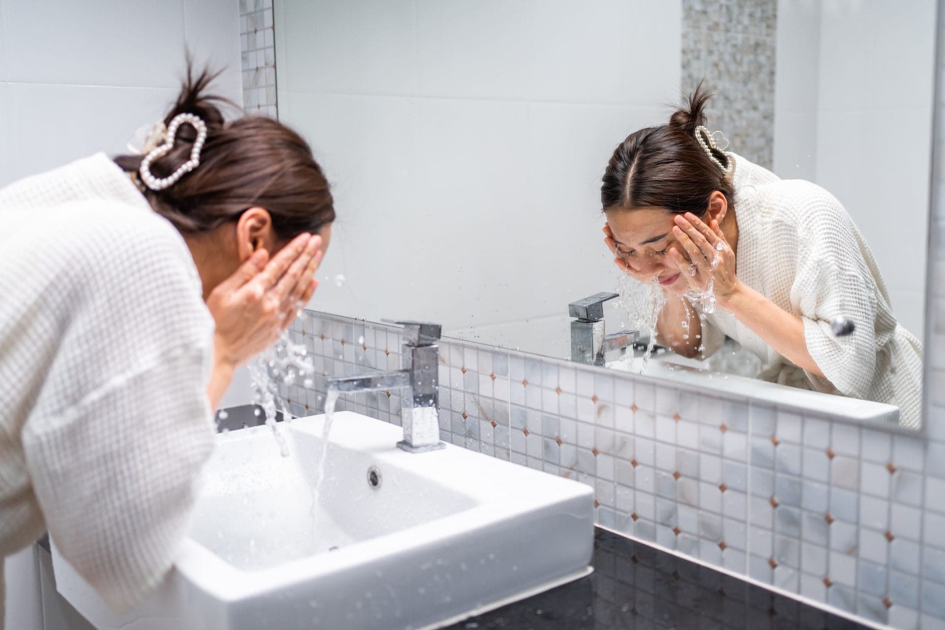 asian-beautiful-woman-washing-her-clean-face-with-2023-11-27-05-25-24-utc(1)