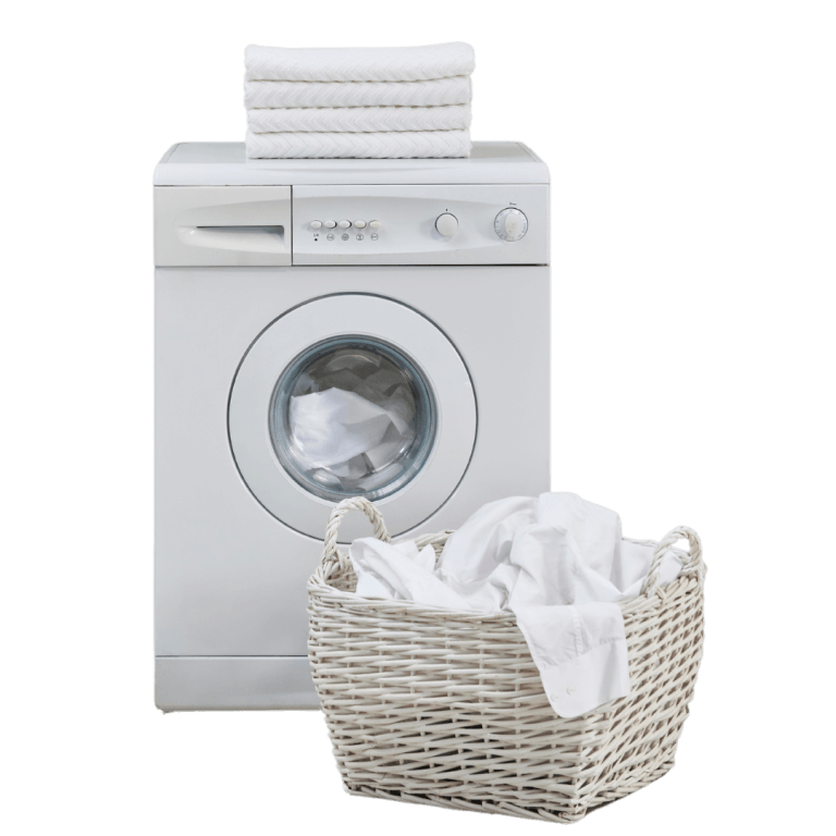 A front-loading washing machine with a stack of folded white towels on top and a white wicker laundry basket filled with white clothes in front.