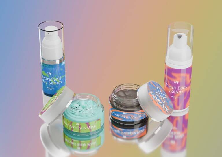 A collection of skincare and haircare products on a reflective surface with a gradient background. The products include HydraPearl Face Serum, Foam Body Lotion, Hair and Scalp Mask, and Purifying Shampoo Paste.