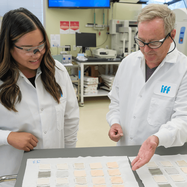 Two scientists in white lab coats with 