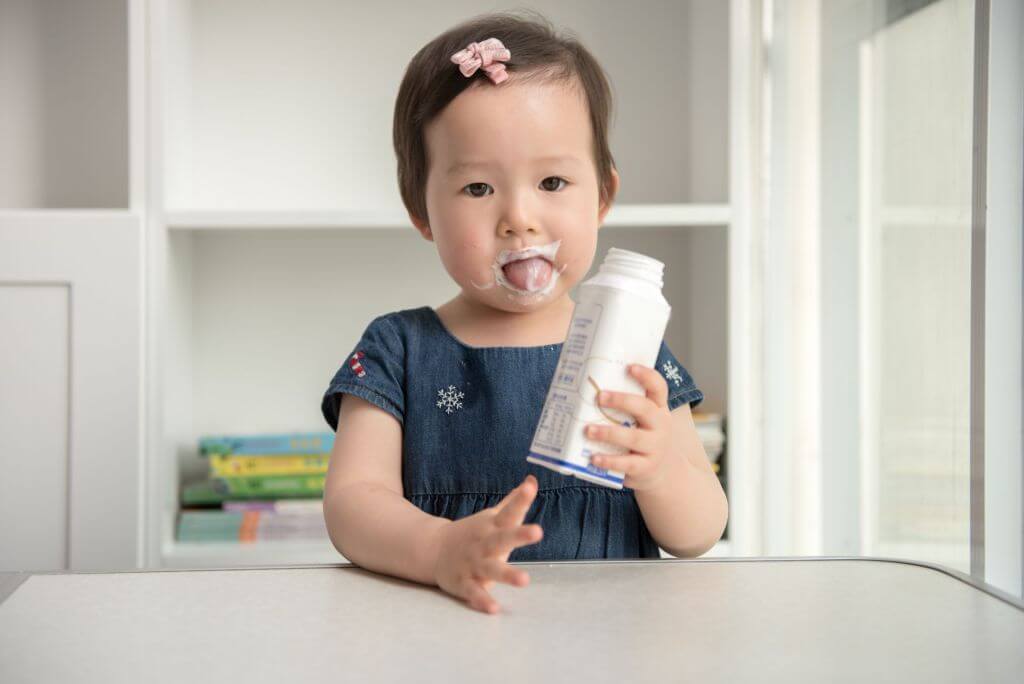 little girl drinking yogurt
