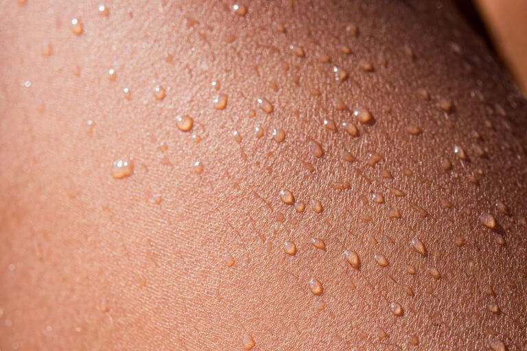 Close-up of skin with water droplets.