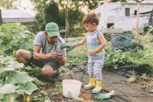 Parent and child outside gardening in an urban garden environment