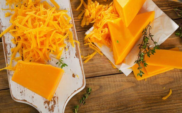 American cheddar cheese grated on a plate