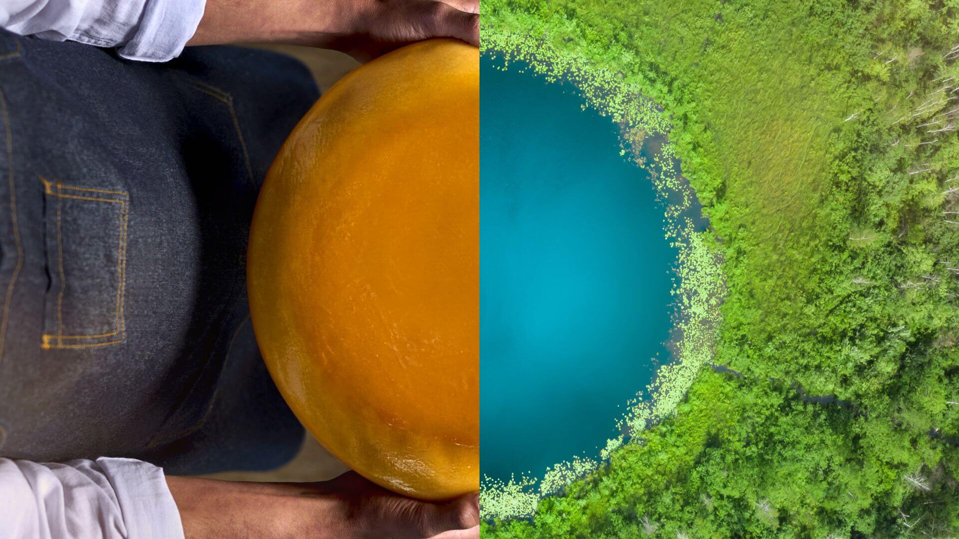 A person holding a cheese wheel next to a rounded lake representing sustainability