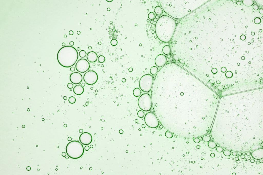 green-artistic-of-oil-drop-floating-on-the-water-2024-12-07-02-38-33-utc